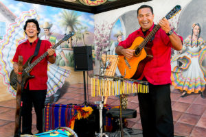 Old Town Market performers playing guitar onstage